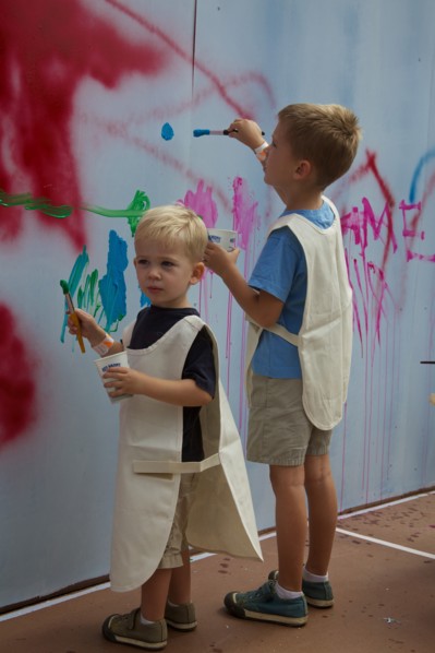 Two Young Boys Painting on Wall