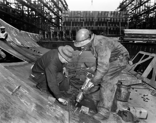 Tightening Bolts with Pneumatic Wrench during Construction of Liberty ship Frederick Douglass, Bethlehem-Fairfield Shipyards, Baltimore, Maryland, USA, Roger Smith, U.S. Office of War Information, May...