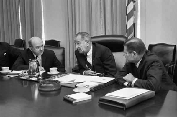 U.S. Secretary of Defense Robert McNamara (right), U.S. President Lyndon Johnson and U.S. Secretary of State Dean Rusk, seated at a table after McNamara's return from South Vietnam, Washington, D.C., ...