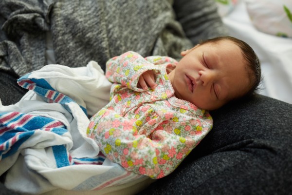 Newborn Baby Girl Sleeping in Mother's Lap in Hospital