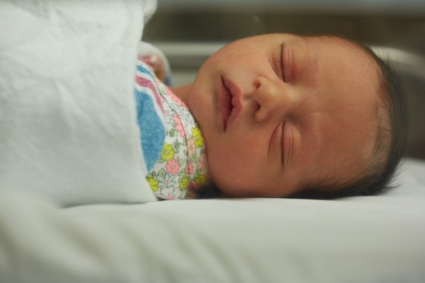 Head and Shoulders Portrait of Sleeping Newborn Baby Girl in Hospital