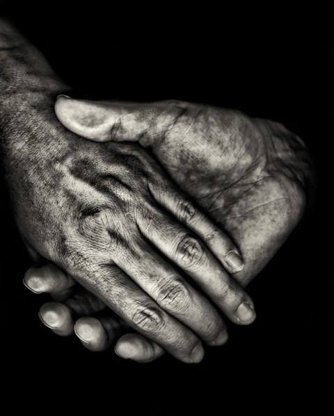 Two Hands on Black Background