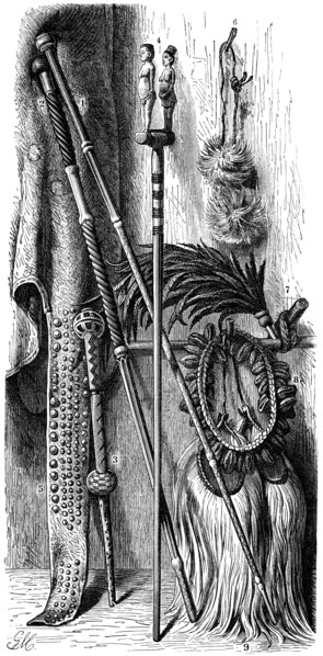 South African Native items: 1, 2 Chieftan's Staffs; 3, Dancing Staff; 4, Fetish Stick; 5, Mantle Cloth with Trailing Ornamentation; 6, Fly Brush worn on Head; 7, Plume of Feathers; 8, Collar for Danci...