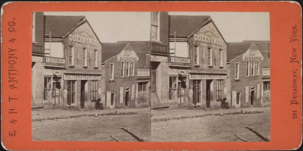 Man with Rifle sitting outside Commercial Building used as Slave Market