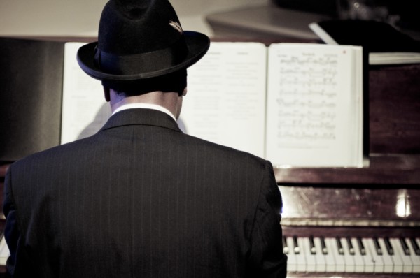 Rear View of Man playing Piano