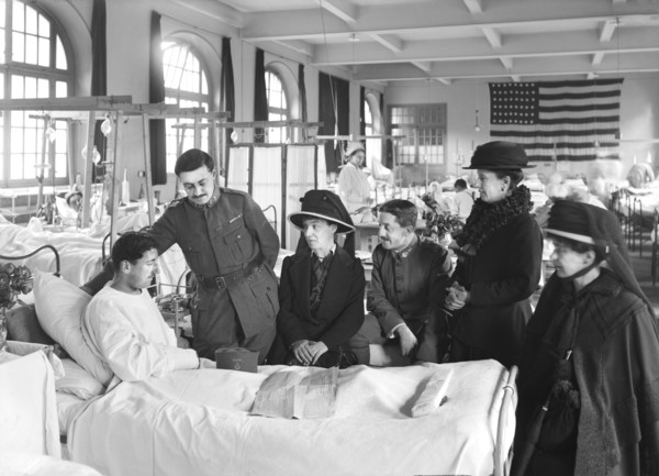 Relatives visiting a wounded French soldier in American Military Hospital No. 1 supported by American Red Cross
