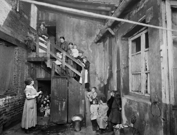 American Red Cross Nurse visiting Refugees in Housing Condemned before the War