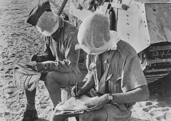 Two British Soldiers with their heads covered by Mosquito Nets