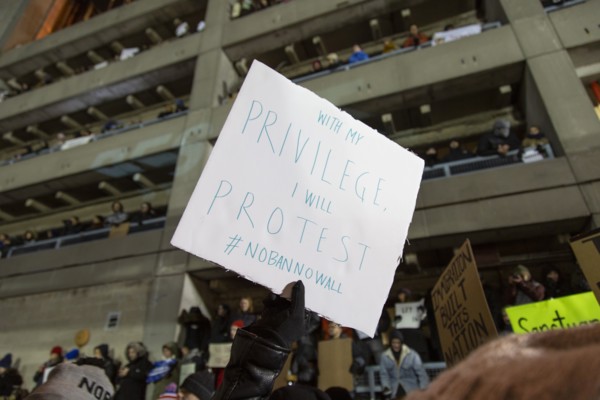 Protester holding Sign "With my Privilege I will Protest", Protest against Muslim Travel Ban,