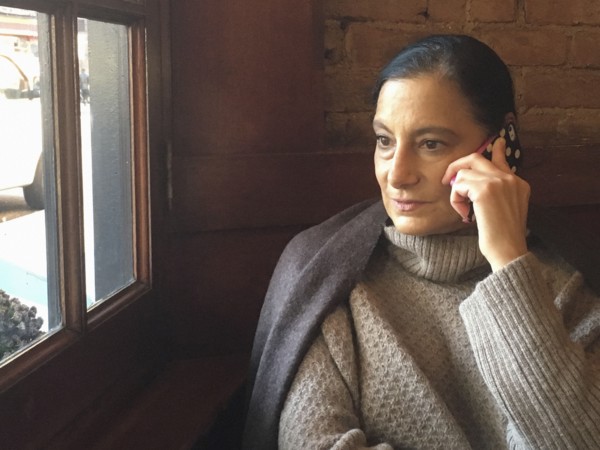 Mid-Adult Woman talking on Cell Phone in Restaurant,,