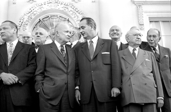 U.S. President Dwight D. Eisenhower standing with U.S. Senator from Texas Lyndon B. Johnson (center), U.S. Secretary of State John Foster Dulles (right) and other guests