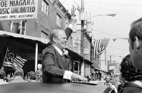 U.S. President Gerald Ford waves to crowd from the sunroof of a car in Philadelphia, Pennsylvania