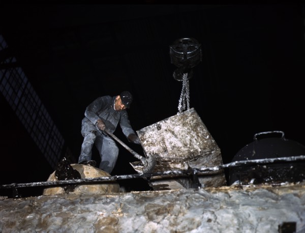 Worker spreading Asbestos Mixture on Boiler of Locomotive at Chicago and North Western Railroad]