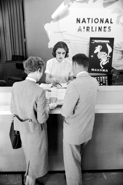 Couple scheduling trip at National Airlines Office