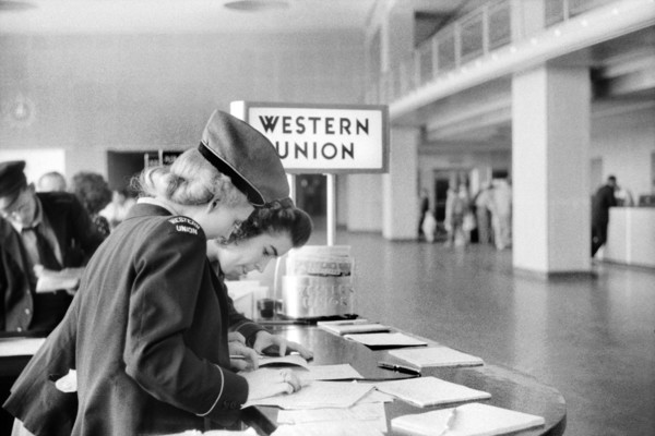 Two Western Union Employees filling out Paperwork