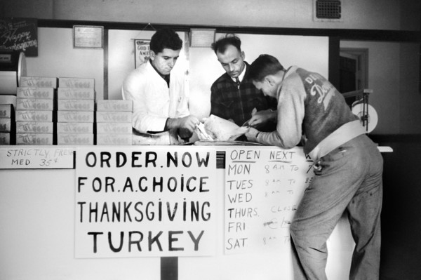 Workers reviewing Paperwork in Meat Store