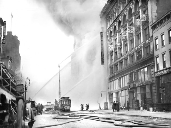 Fireman spraying water on burning building