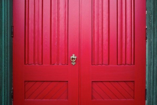Red Wood Doors with Ornate Metal Handle