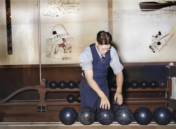 Man choosing bowling ball at bowling alley