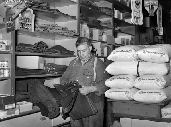 Man shopping for farm clothes in general store