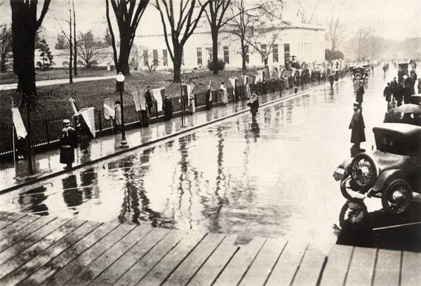 Suffragists picketing with banners