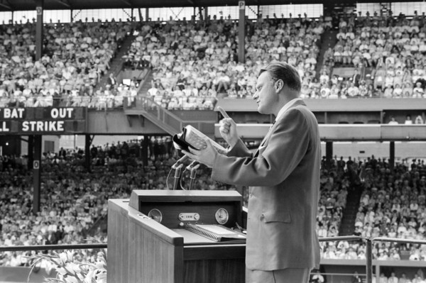Evangelist Billy Graham preaching to crowd at crusade, Griffith Stadium, Washington, D.C., USA,