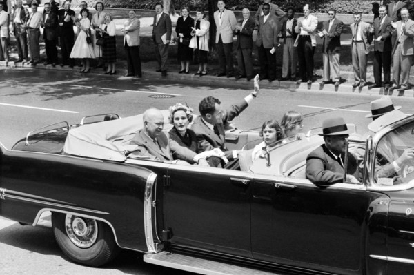 U.S. President Dwight Eisenhower riding in convertible car with U.S. Vice President Richard Nixon,