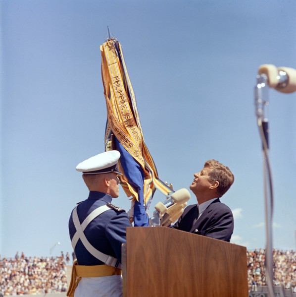 U.S. President John F. Kennedy receiving U.S. Air Force Academy ceremonial flag from unidentified