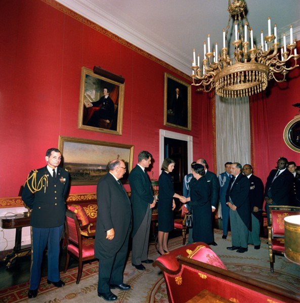 Jacqueline Kennedy, standing next to U.S. Senator Edward Kennedy, shaking hands with Minister of