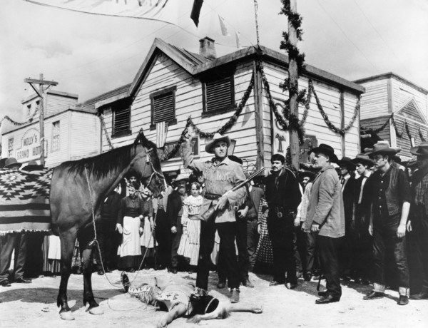 Stewart Granger (standing center with rifle), on-set of the western film, "Flaming Frontier",