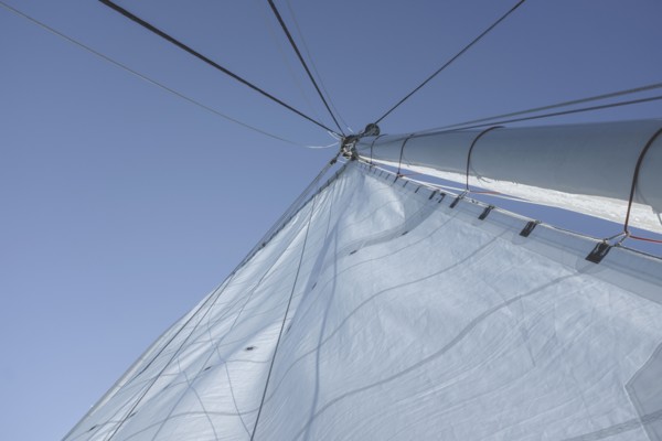 Low angle view of large sail and mast