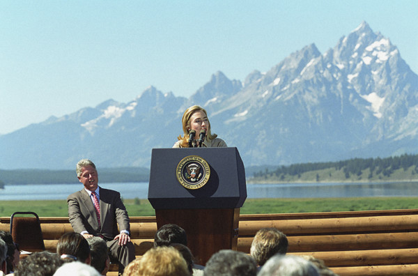 U.S. First Lady Hillary Rodham Clinton delivering remarks, as U.S. President Bill Clinton looks on,
