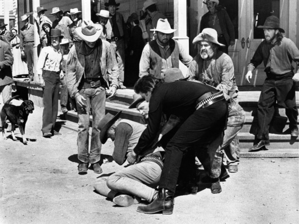 Robert J. Wilke (on ground), Johnny Cash (lifting Wilkie), Kirk Douglas (head partially obscured),