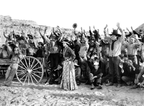 Dorothy Appleby (standing center), on-set of the western film, "King Of The Wild Horses", Columbia
