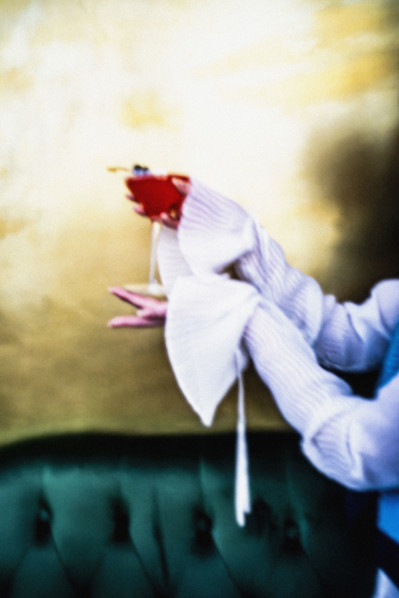 Woman holding a pink cocktail in martini glass