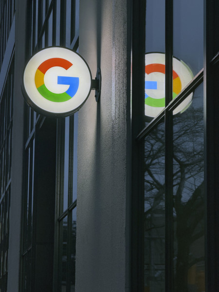 Google store at night, close-up view of illuminated company logo on building exterior, New York