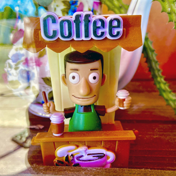 Miniature plastic coffee barista  in window display