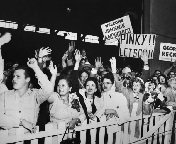families of returning Prisoners of War waving and greeting USNS General Nelson M. Walker as it