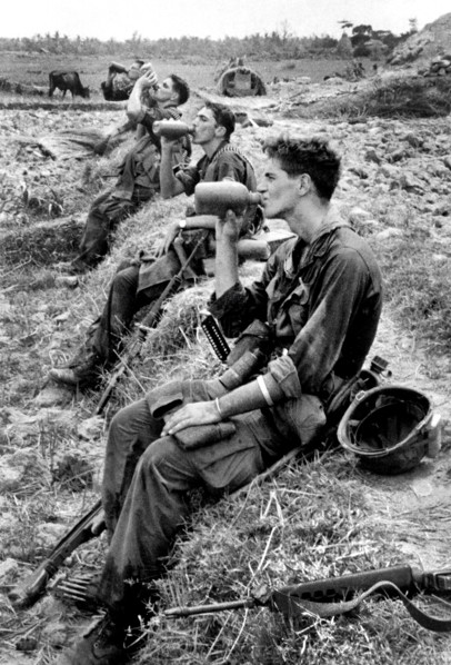 Members of U.S.25th Infantry Division drinking from their canteens during break in patrol