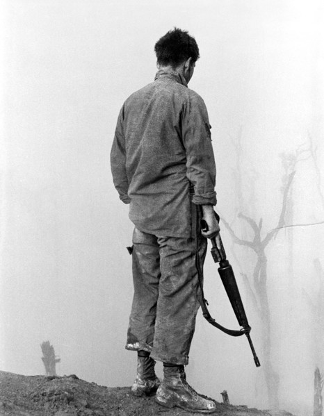 Member of the U.S. 5th Infantry Division (Mechanized) looking out over fog-shrouded A Shau Valley,