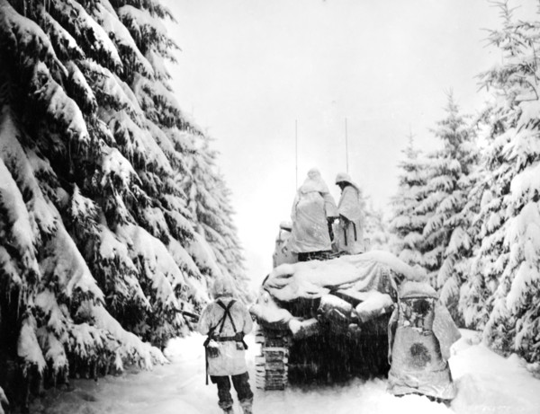 U.S. tank and Infantrymen of the 82nd Airborne Division pushing through snow, near Herresbach,
