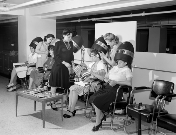 Women drying their hair in beauty shop at Crowley-Milner department store, Detroit, Michigan, USA,