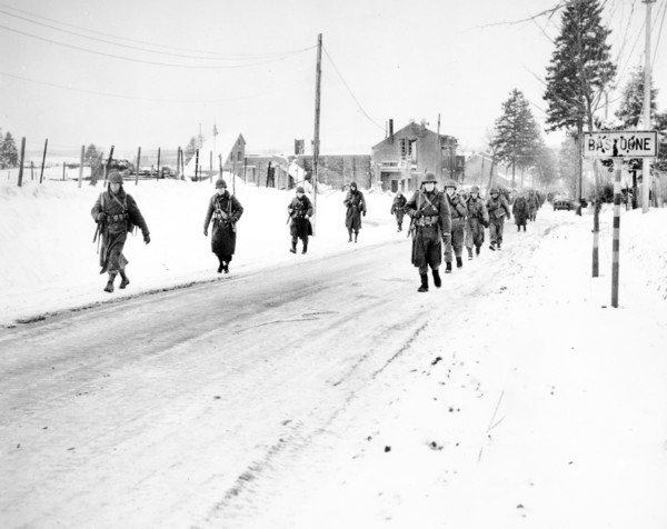 Members of U.S. 101st Airborne Division on the move out of  Bastogne, Belgium, to drive Germans who