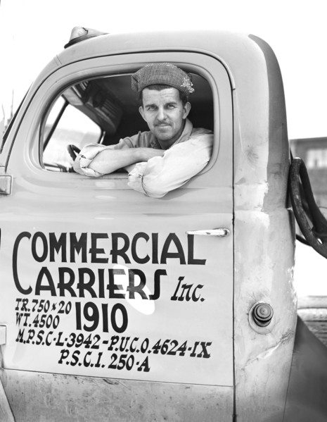 Truck driver, Commercial Carriers, Inc., transports U.S. military vehicles from manufacturing