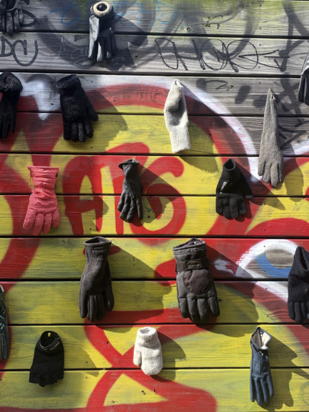 Lost gloves and mittens hanging on wood fence, Brooklyn, New York, USA