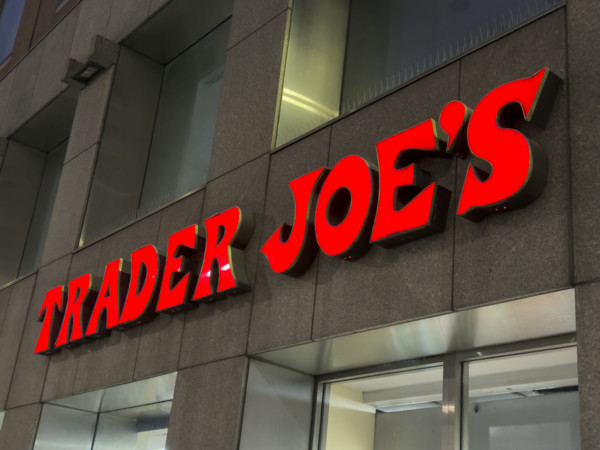 Trader Joe's grocery store, building exterior with company sign at night, New York City, New York,