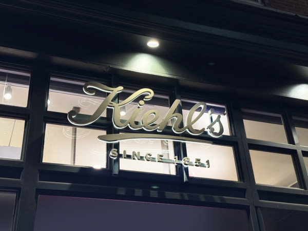 Kiehl's flagship store, company sign on building exterior at night, 109 Third Avenue, New York