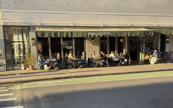Group of people enjoying outdoor dining on sunny day, Rosemary's Restaurant, New York City, New