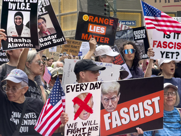 Demonstrators participating in "Our City, Our Fight: Protect Migrants, Protect the Planet" protest,