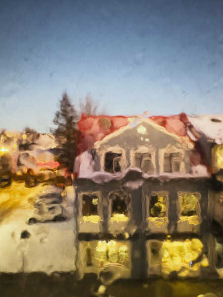 Street scene viewed through blurred raindrops on window, Hafnarfjordur, Iceland